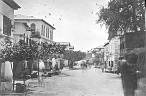  
Code: 0002 4038
Category: Views of Cape Coast

7. View of Commercial Street, Cape Coast

It is likely that Hendrik Muller visited Cape Coast after he visited Elmina. Cape Coast is the former British Capital of the Gold Coast, situated circa 15 kilometres east of Elmina. All photo's of Cape Coast show views of the town and were most likely bought by him.

Photo of Commercial Street, the business centre, towards the south. The high building middle left was originally a merchant's house, but for a long time has also been used as the palace of the traditional king (omanhin) of Cape Coast. In 2001 the building housed a restaurant. Notice the black blotches in the street: persons who escaped the image because of the long exposure time.

